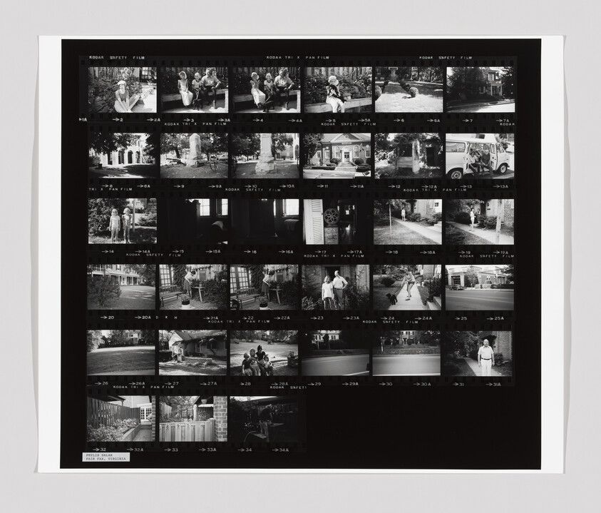 Contact sheet of black-and-white film strips showing family scenes, houses, and outdoor moments.