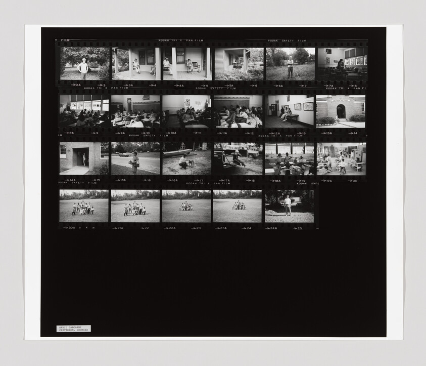 Black-and-white film contact sheet showing multiple small photographs of people in classrooms and outdoor group scenes.