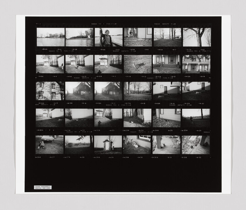A sheet of black-and-white film negatives shows outdoor scenes, a child, a house, and a bicycle.