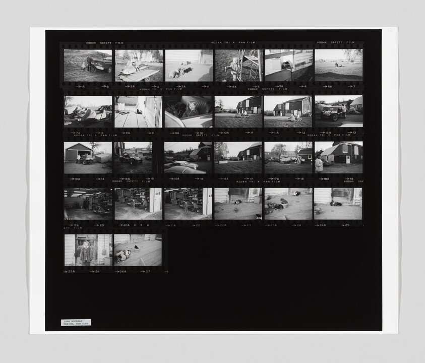 Black-and-white contact sheet showing rows of small film negatives with people, cars, and buildings.