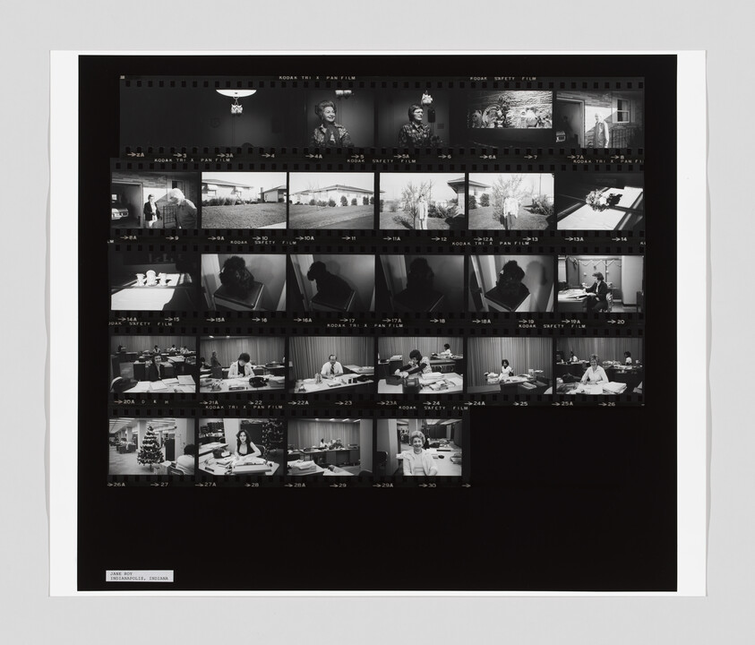 A contact sheet with multiple black-and-white photos showing people working at desks, a Christmas tree, and office scenes.
