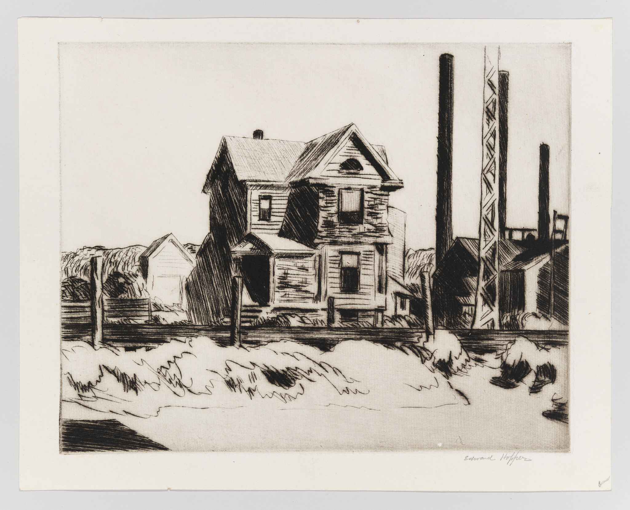 A black and white etching depicting a contrast between residential and industrial settings. In the foreground, there's a two-story house with a gabled roof and a smaller outbuilding to its left. In the background, several tall smokestacks rise above industrial buildings, suggesting a factory or plant. The scene is devoid of people, creating a stark, quiet atmosphere. The artist's signature is visible in the lower right corner.