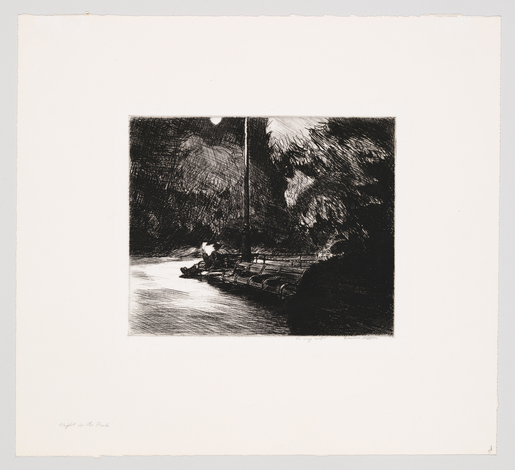 A lone figure sits on a wooden dock under a lamppost by dark water and trees.