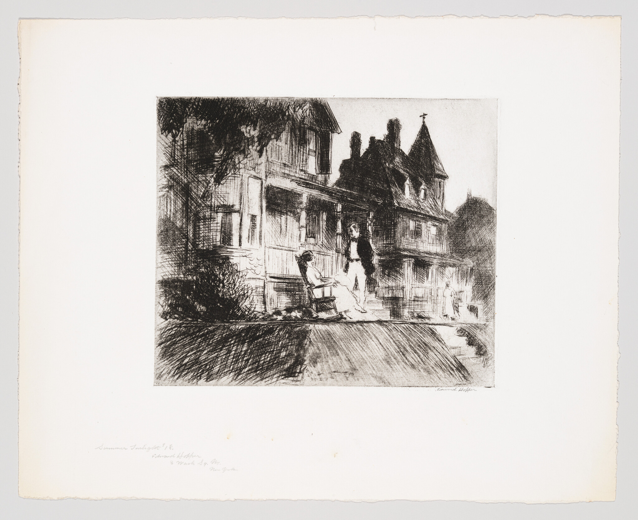 A man stands and a woman sits on the porch of an old Victorian house.