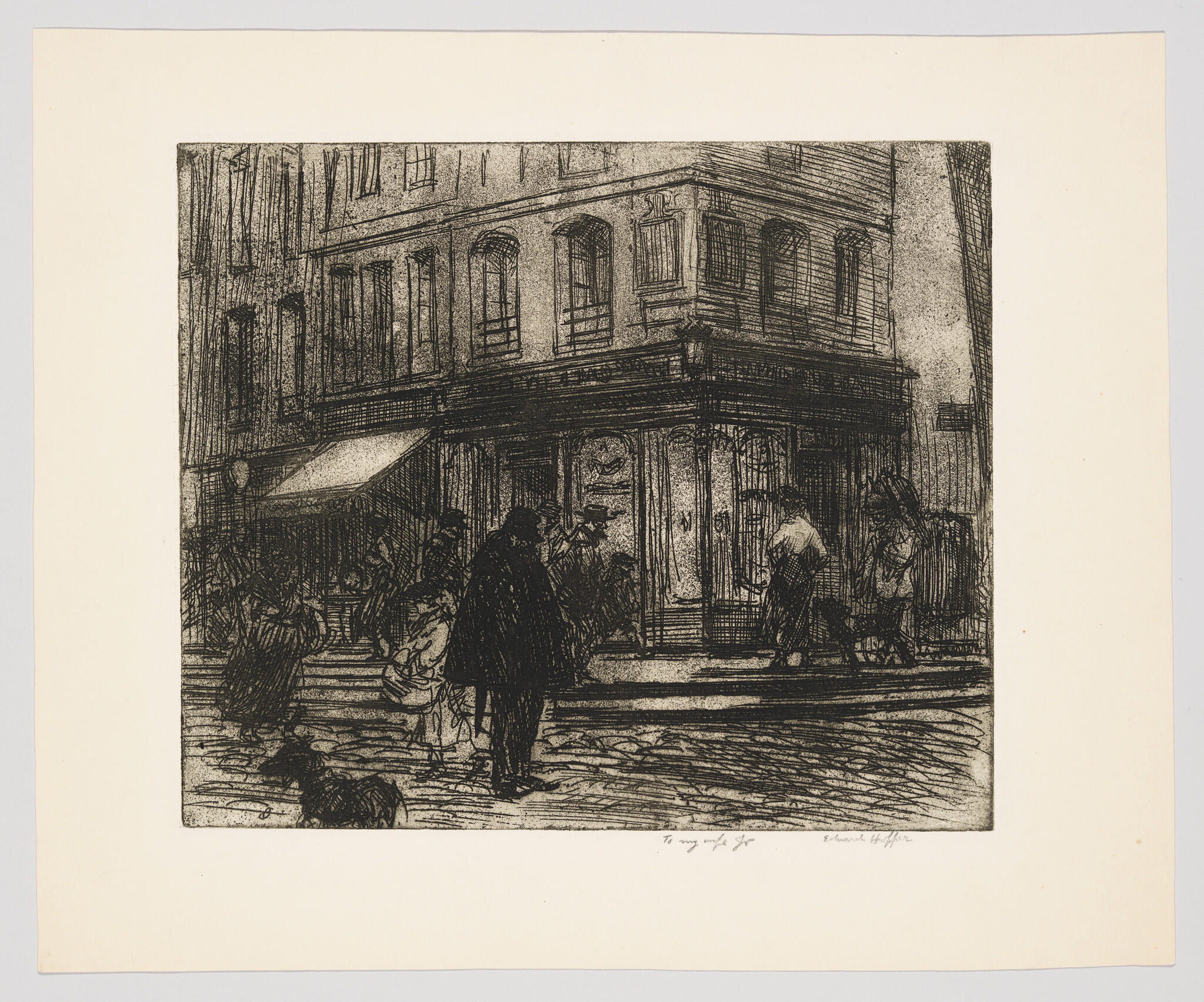 People and a dog stand and walk near a corner shop on a busy city street.