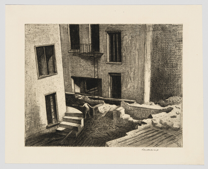 A narrow urban courtyard between apartment buildings with stairs, balconies, and scattered rubble.