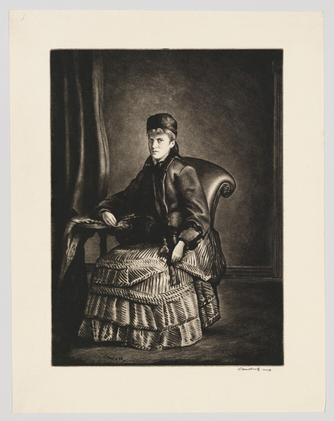 A seated woman in Victorian dress and hat rests one hand on a table and looks forward.