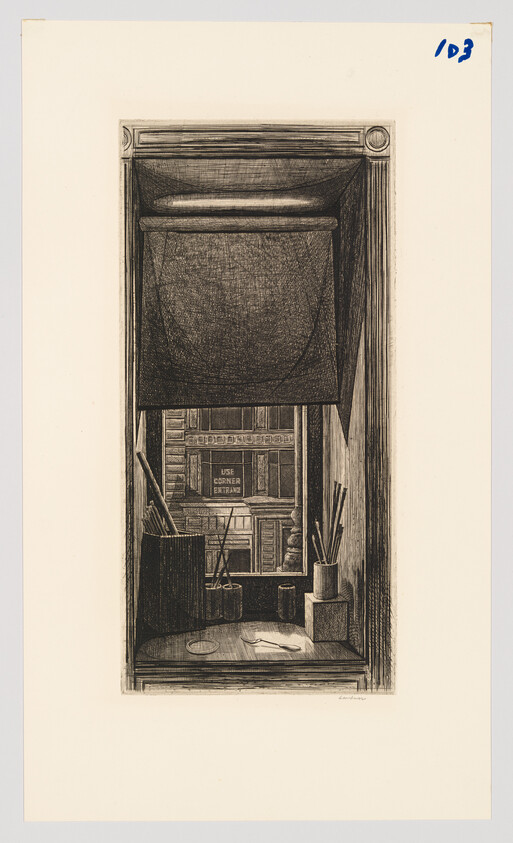 A narrow studio window with a lowered shade, brushes and tools on the sill, city buildings beyond.