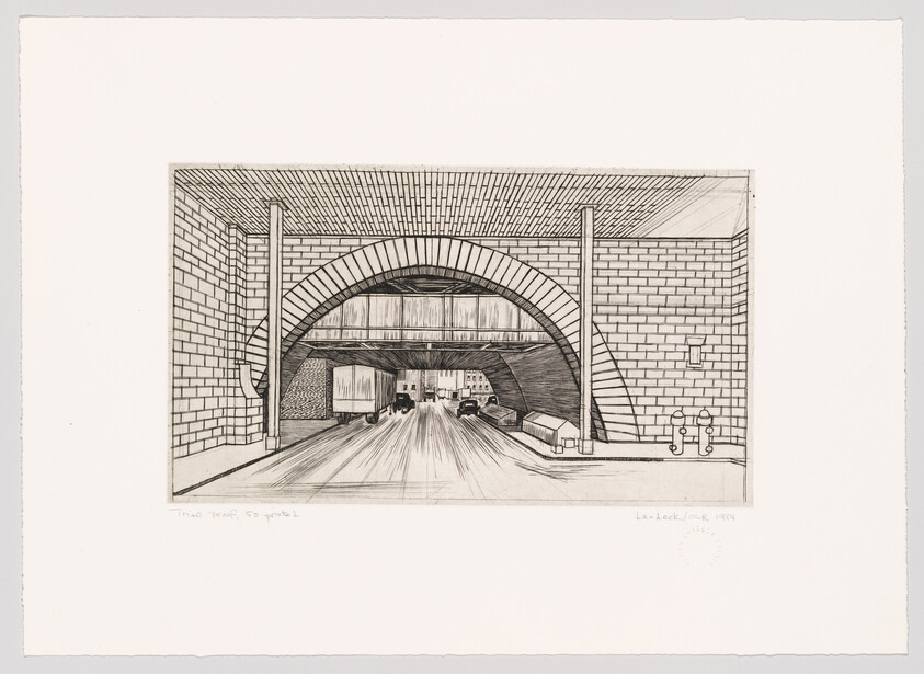 Underpass with brick arch and roadway showing cars and a truck passing through.