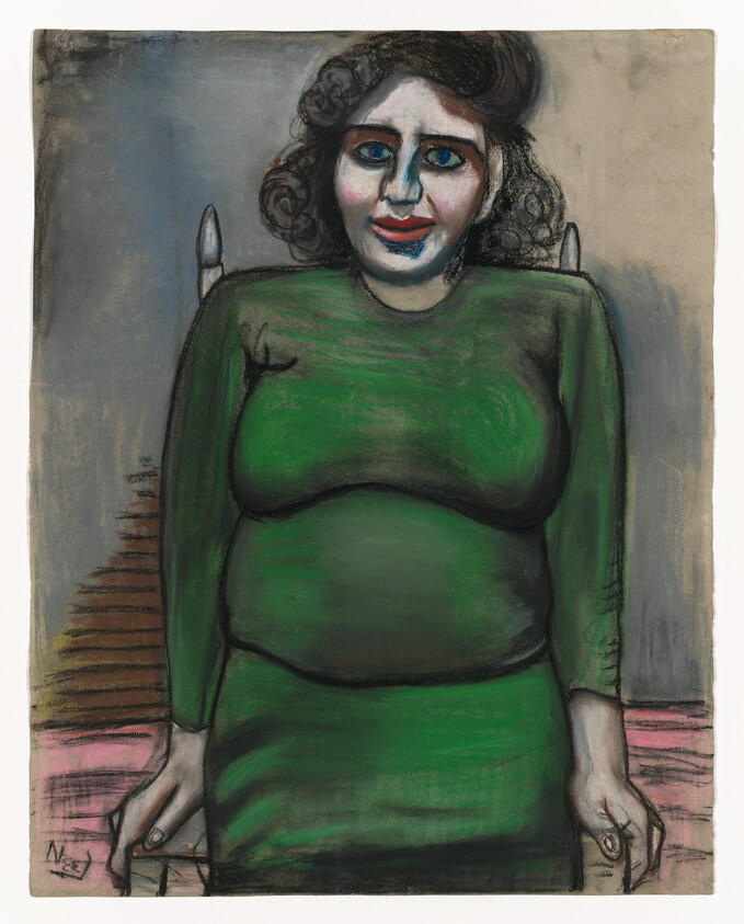 A seated woman in a green dress sits on a chair with hands gripping the seat, smiling.