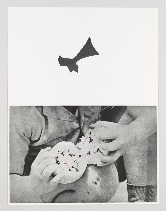 Two children examining a small round object with pins connected by red lines like a constellation.