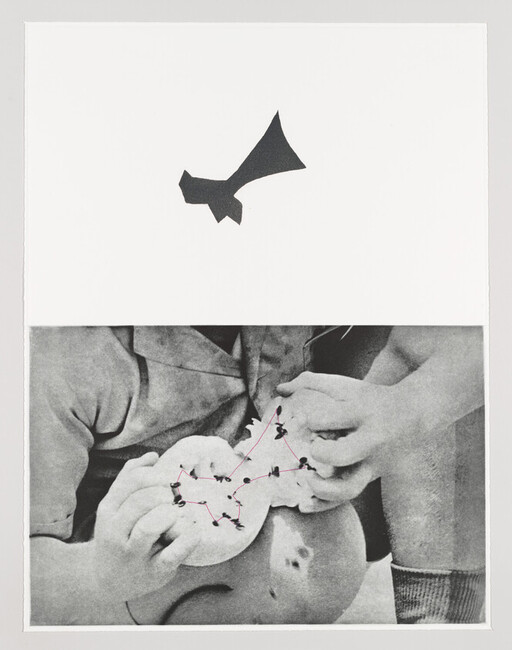 Two children examining a small round object with pins connected by red lines like a constellation.