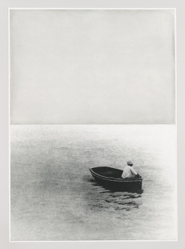 A lone person sits in a small rowboat on calm, empty water near the image center.