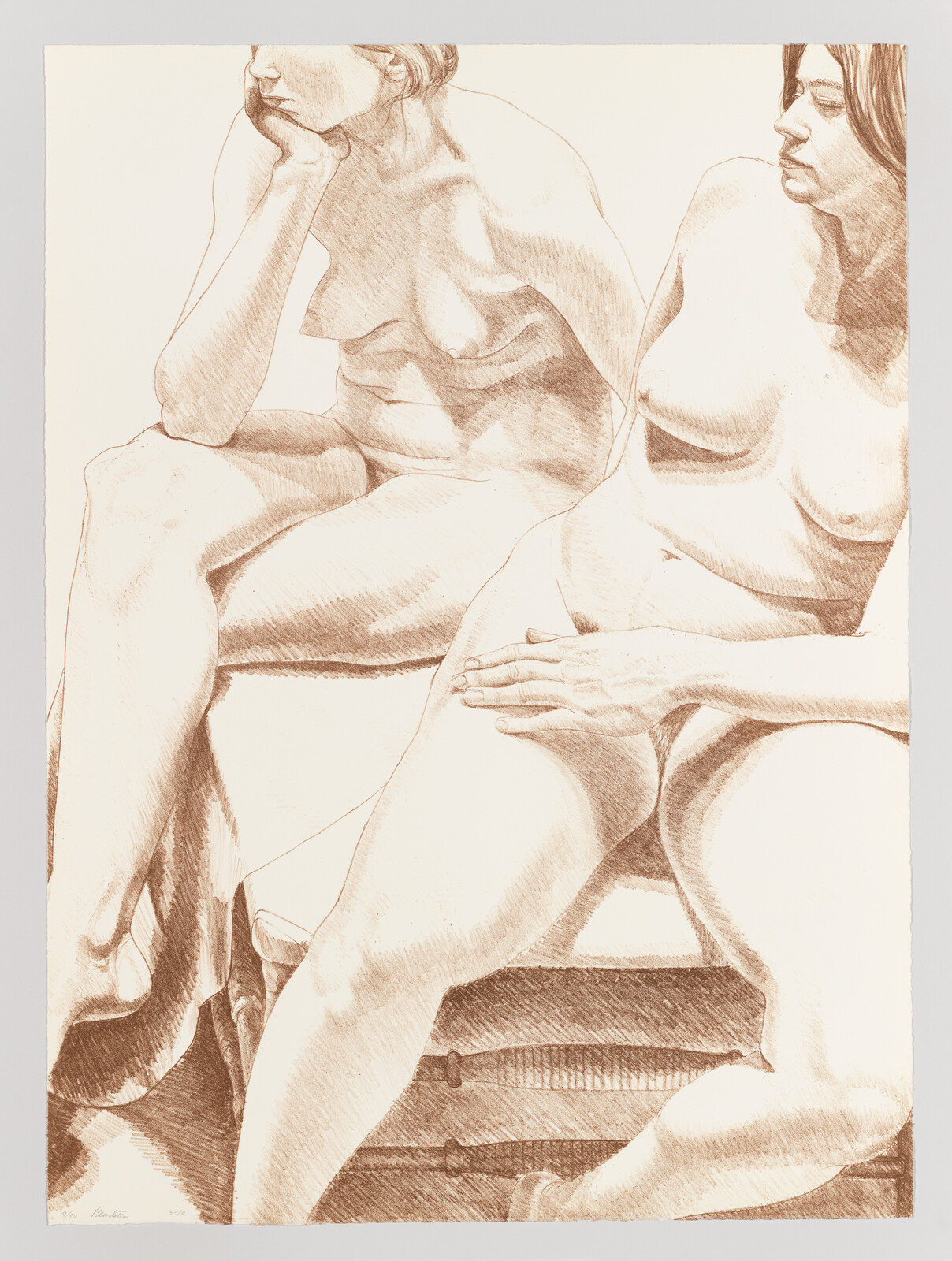 Two seated nude women pose on a bench, one resting her hand on her thigh.