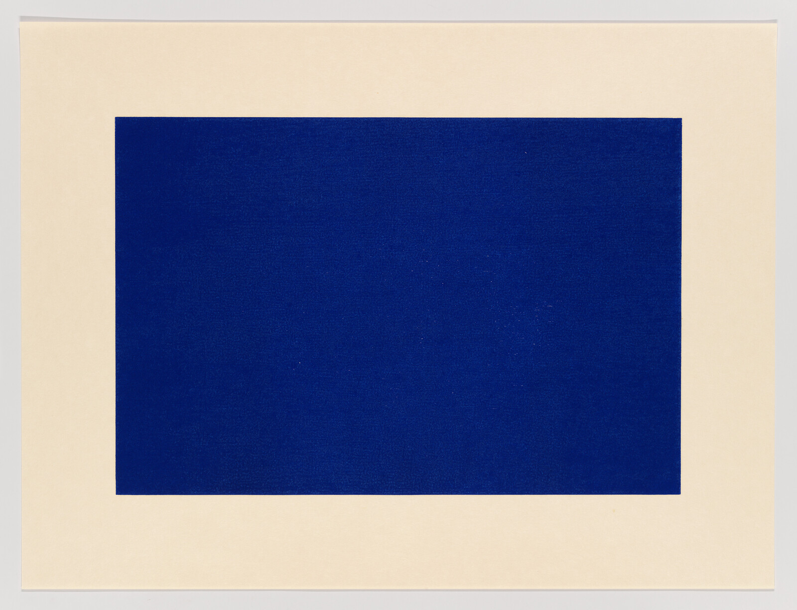 A large solid deep blue rectangle centered on a wide cream-colored paper border.