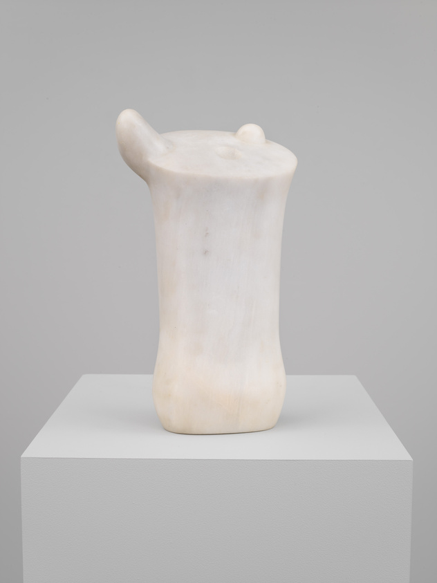 Solid cylindrically-shaped marble sculpture topped with two nub-like protrusions and a small semispherical inset