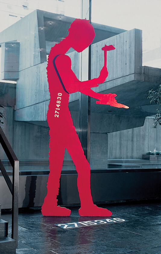 A red silhouette of a person holding a hammer and chisel with numerical codes on body and floor.