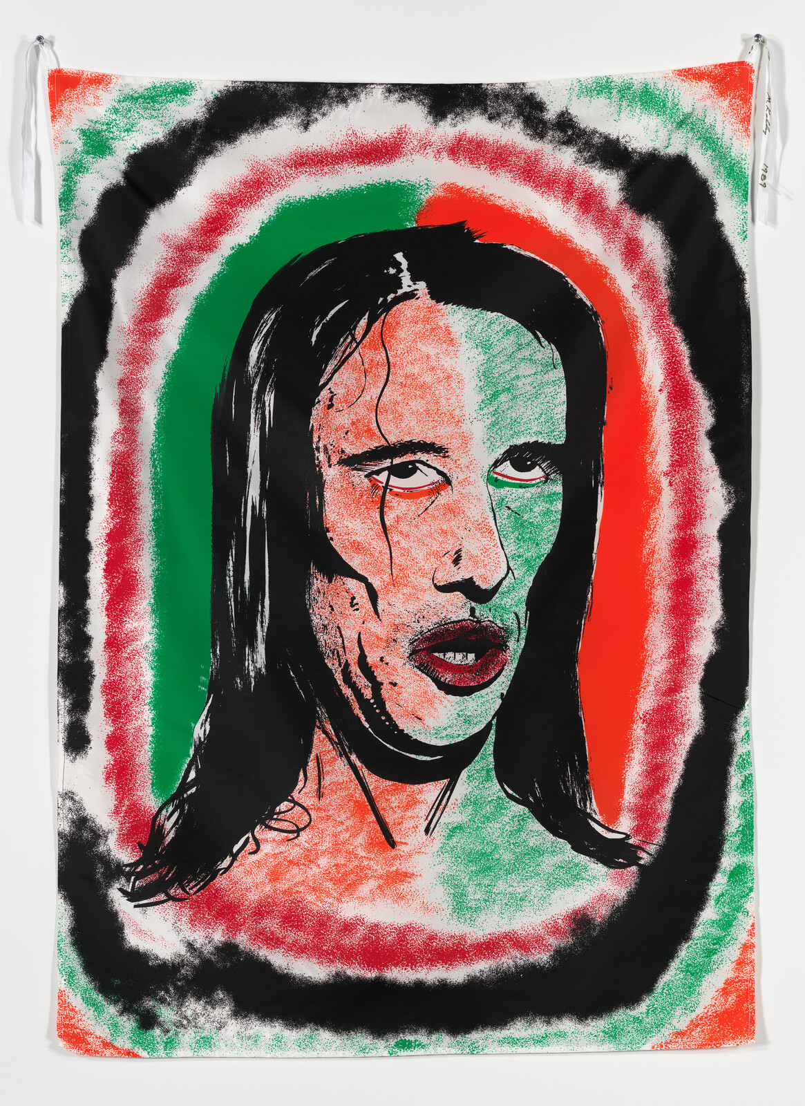 A stylized portrait of a long-haired person with red, green, and black halo-like rings.