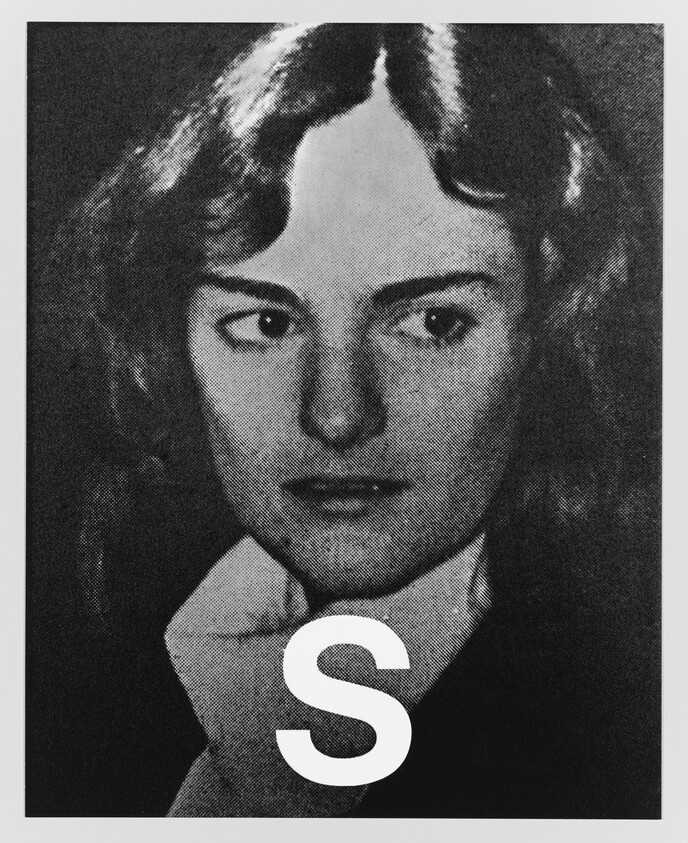 Young woman looking to the side with a large letter S over her lower face.