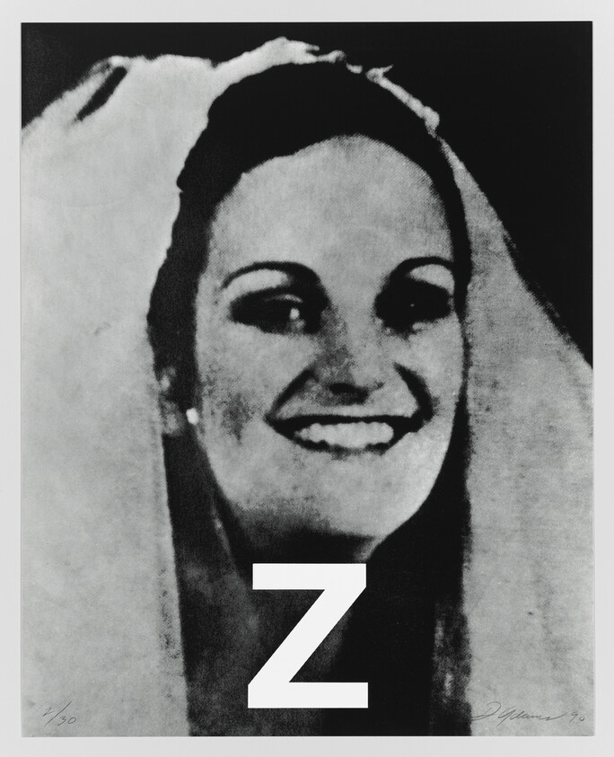 Smiling woman wearing a veil with a large white letter Z over her torso.