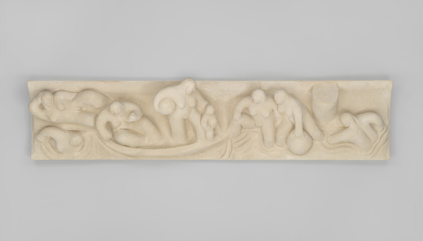 Long carved stone relief showing abstract human figures reclining, bending, and carrying round objects.
