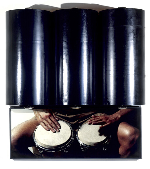 Three large black cylinders over a photo of hands playing two bongos.
