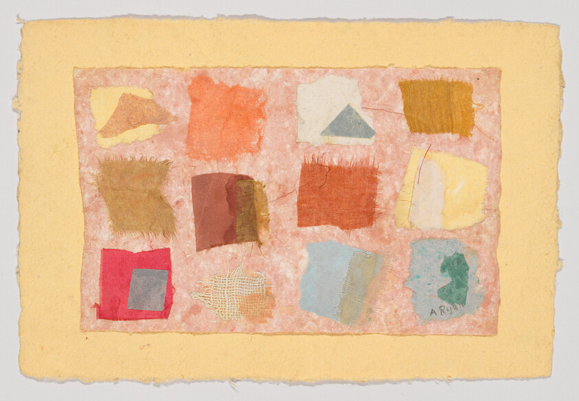 Twelve small fabric and paper patches in warm colors arranged in a rough three-by-four grid on handmade paper.