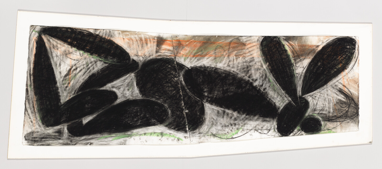 A panoramic abstract artwork featuring bold black shapes that resemble organic forms or stones, with textured charcoal lines and hints of green and orange on a white background, all encased in a simple frame.