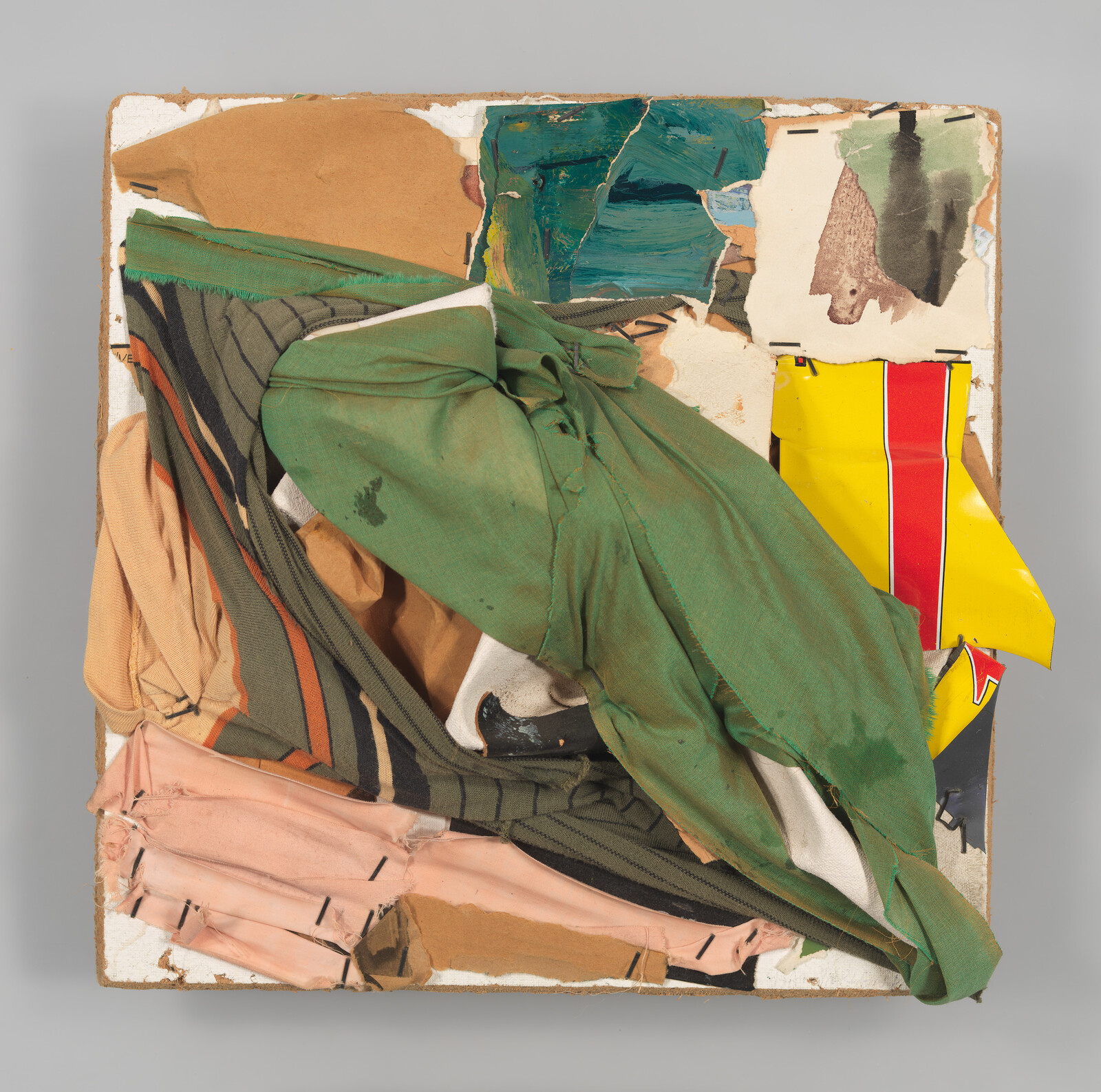 Square collage of layered ripped fabrics and painted paper held together with visible staples.