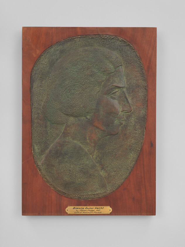 Bronze relief profile of a woman mounted on a rectangular wooden plaque with small name plate.
