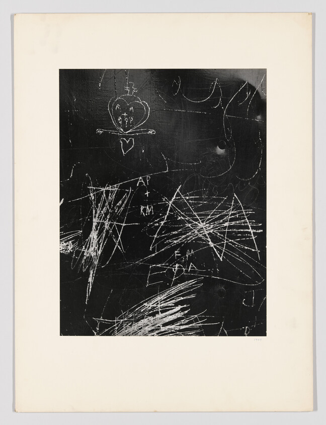 Blackboard-like surface with white chalk scratches, a drawn heart, and initials AP + RM.