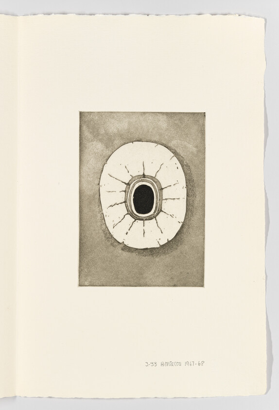 A small circular abstract drawing with a dark central hole and radiating cracks on paper.