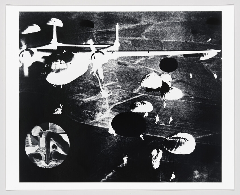 Large transport aircraft releasing paratroopers with multiple parachutes descending over dark terrain.