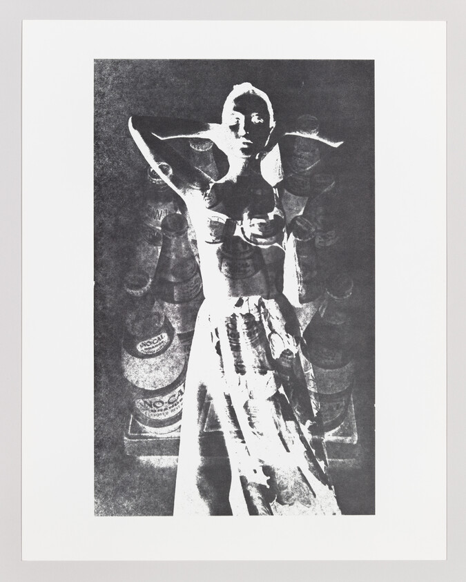 High-contrast black-and-white portrait of a woman posing with her hands behind her head.