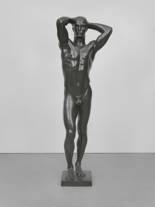 Bronze statue of a nude man standing upright with both hands resting on the back of his head.