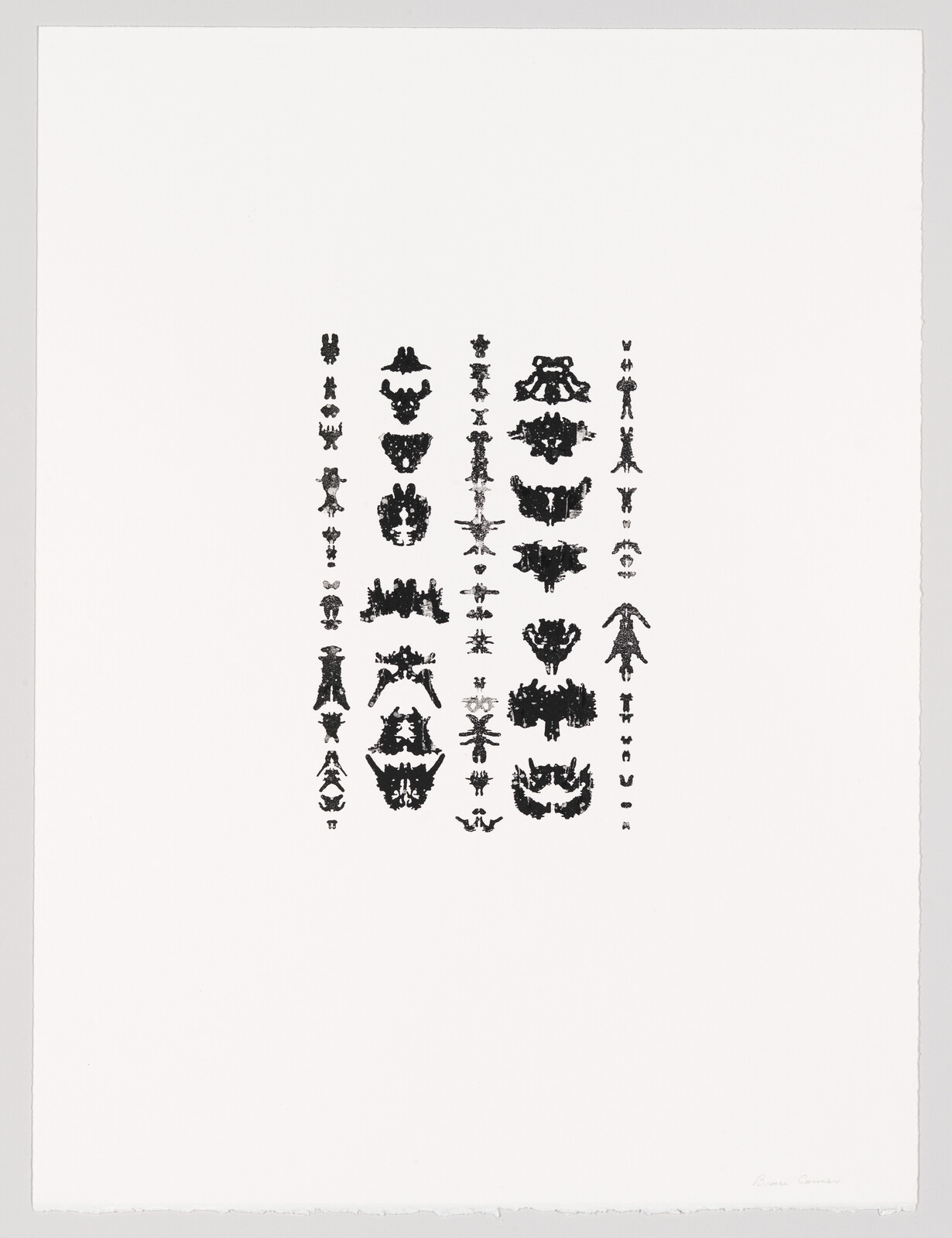 Rows of small black symmetrical inkblot shapes arranged in neat columns on a large white sheet.