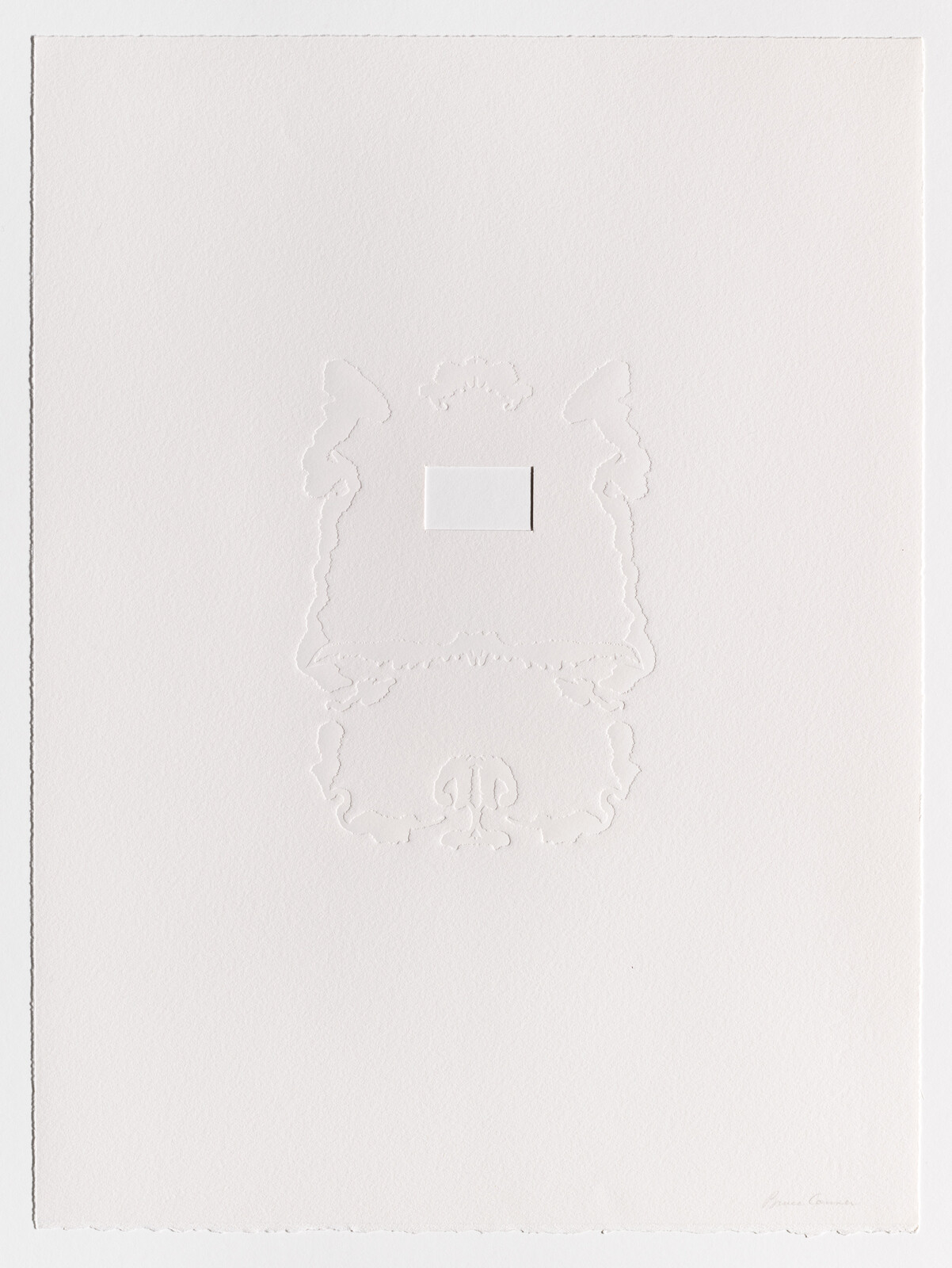 A white paper sheet with an embossed ornamental frame and a small rectangular cutout.