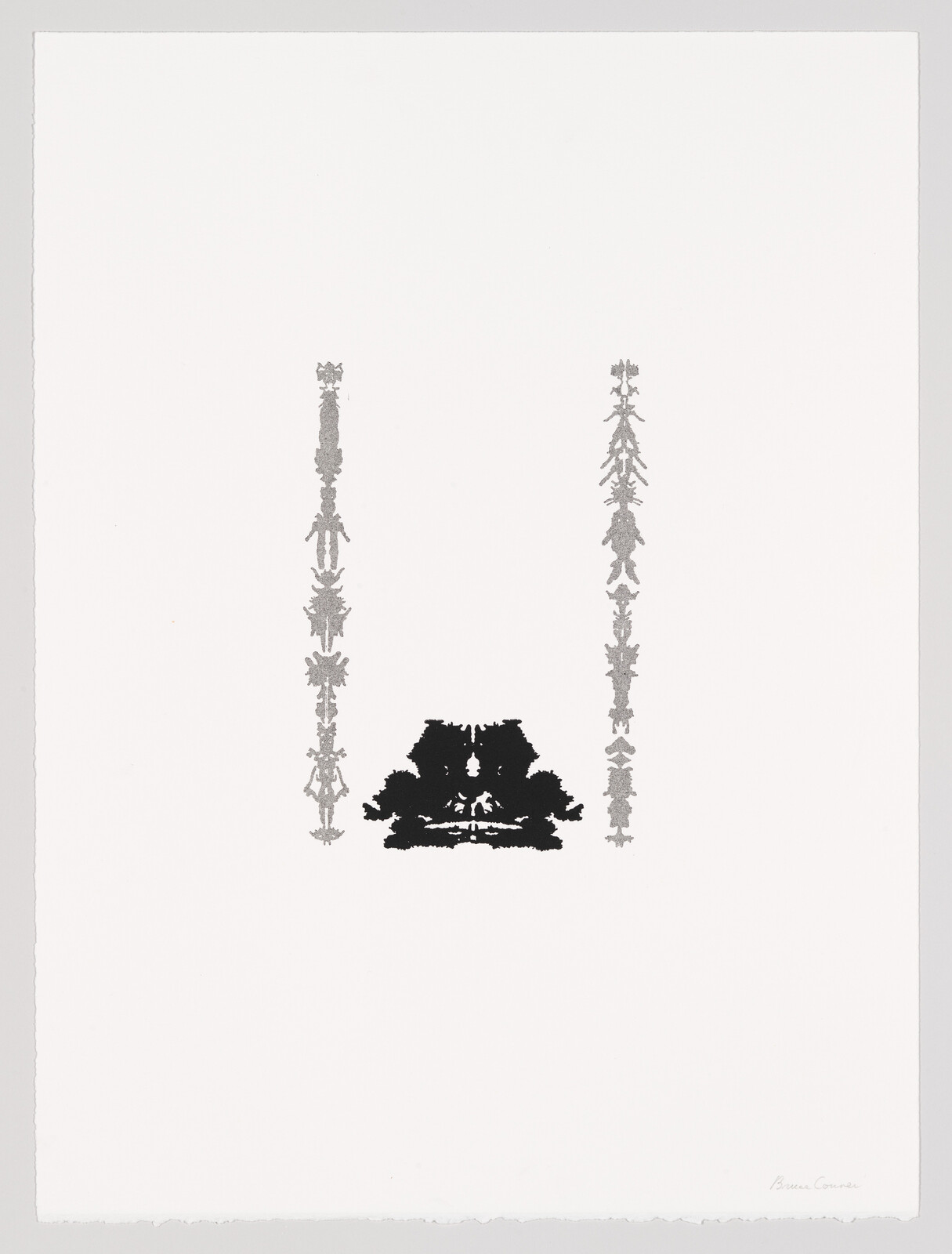 Centered black inkblot sits below two vertical gray decorative columns on a white sheet.