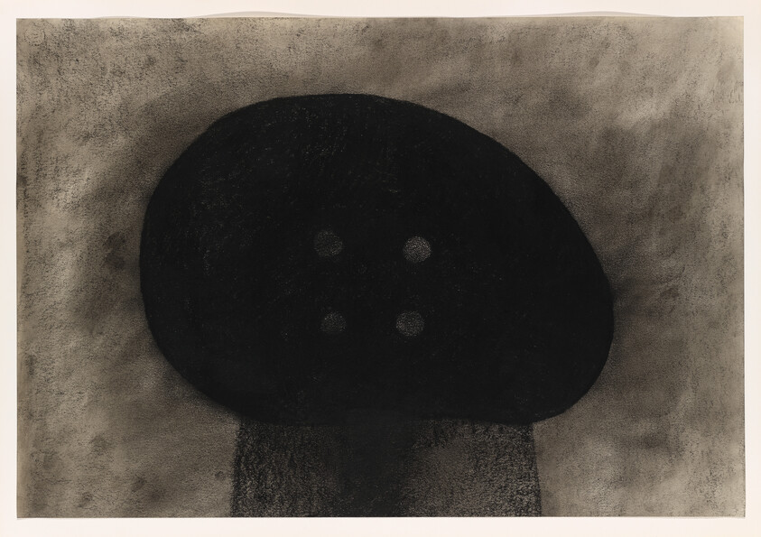 A large dark, rounded mushroom-like shape with four small circular spots above a textured stem.