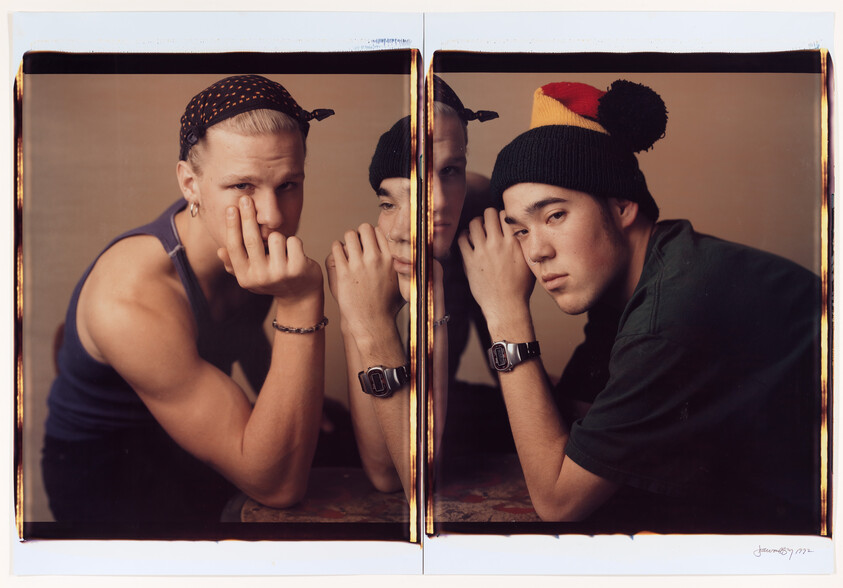 Fractured across a diptych, two short-haired teens in sporty attire look directly at the camera, heads propped on their hands.
