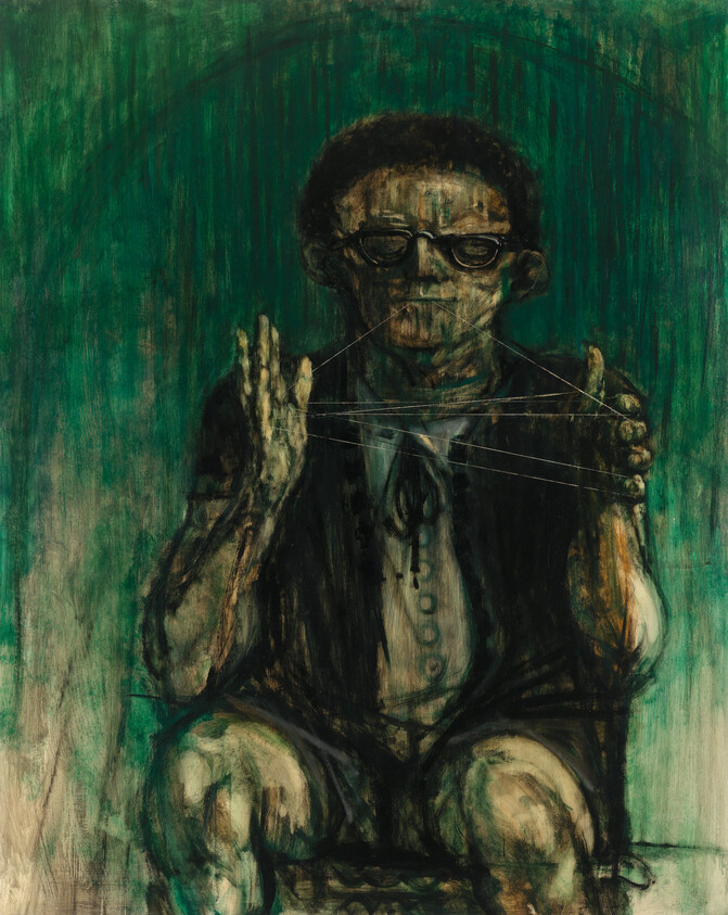 A seated person with glasses plays cat's cradle, holding thin strings against a green background.