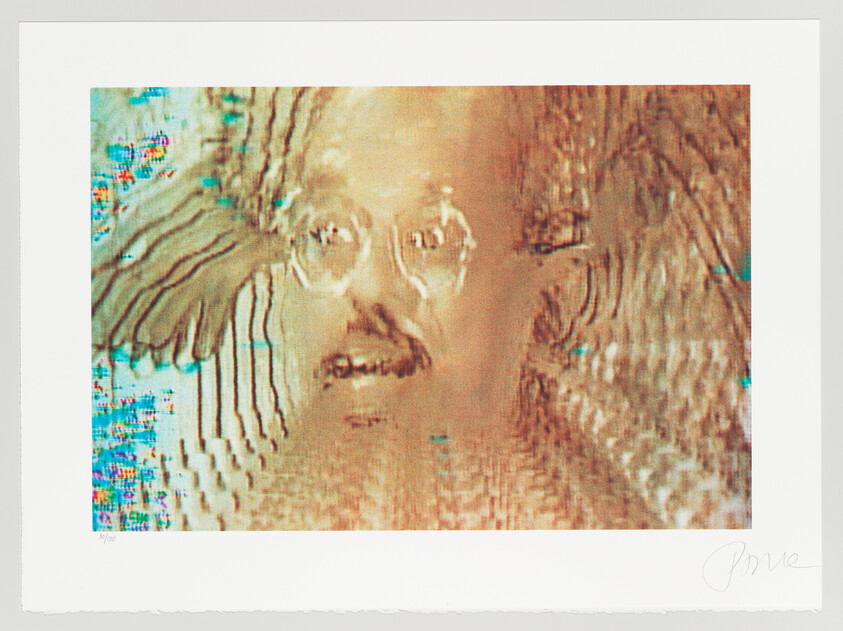 A distorted face with glasses and a mustache appears warped by colorful digital glitch patterns.