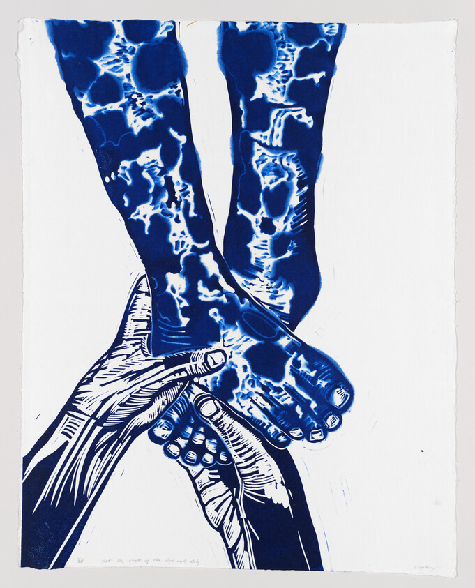Two hands gently holding a pair of crossed feet with blue marbled patterns.