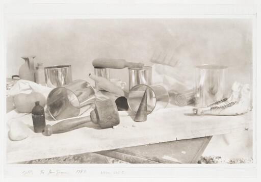 A still-life arrangement of kitchen tools, metal cups, a mallet, rolling pins, and a jawbone on a table.