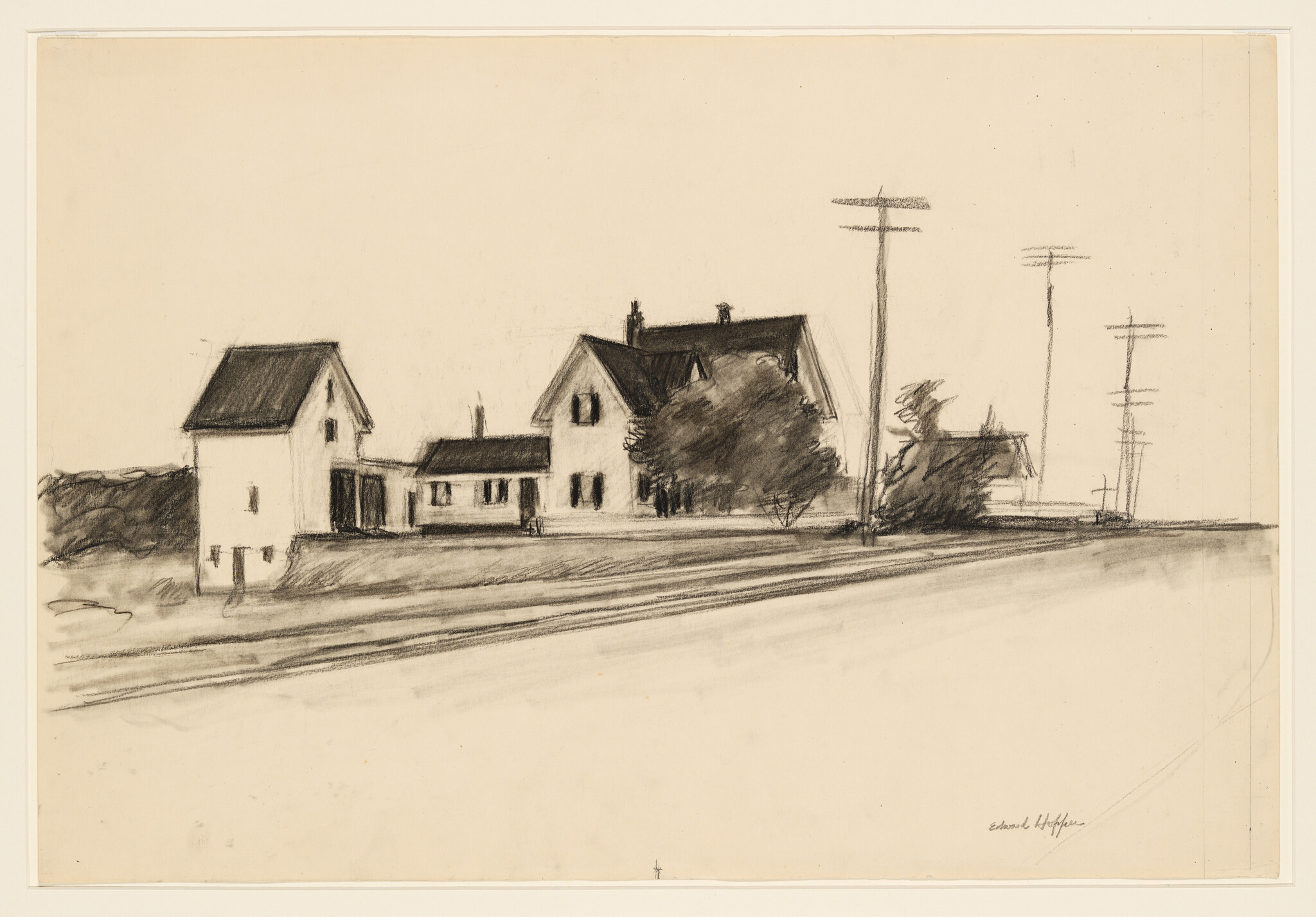Two houses and outbuildings beside a road with utility poles and a large tree.