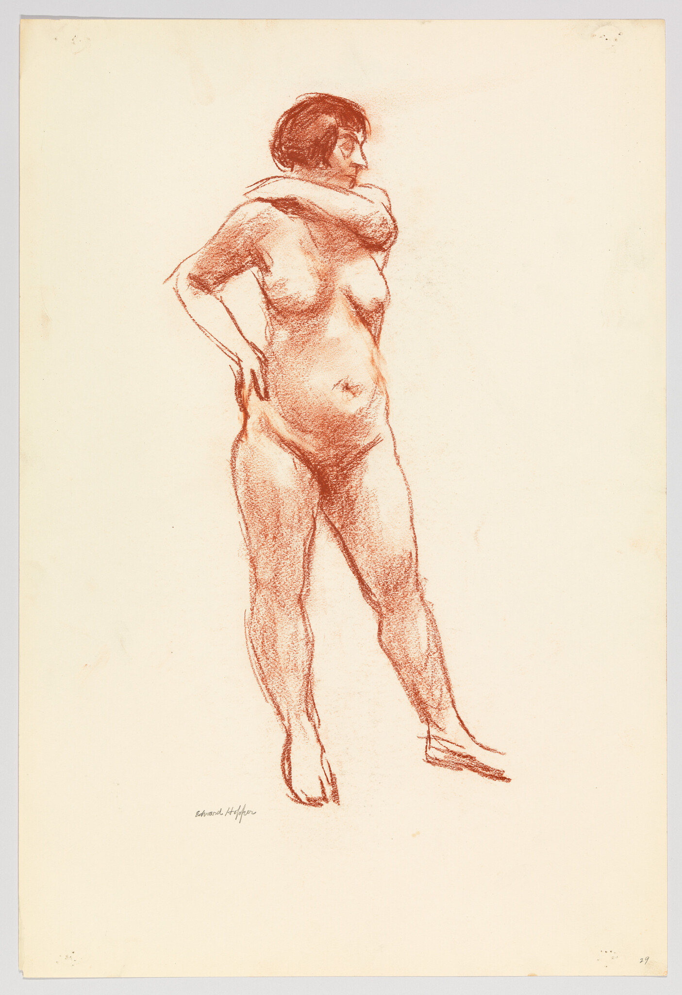 Nude woman standing with one arm across her neck and the other hand on her hip.