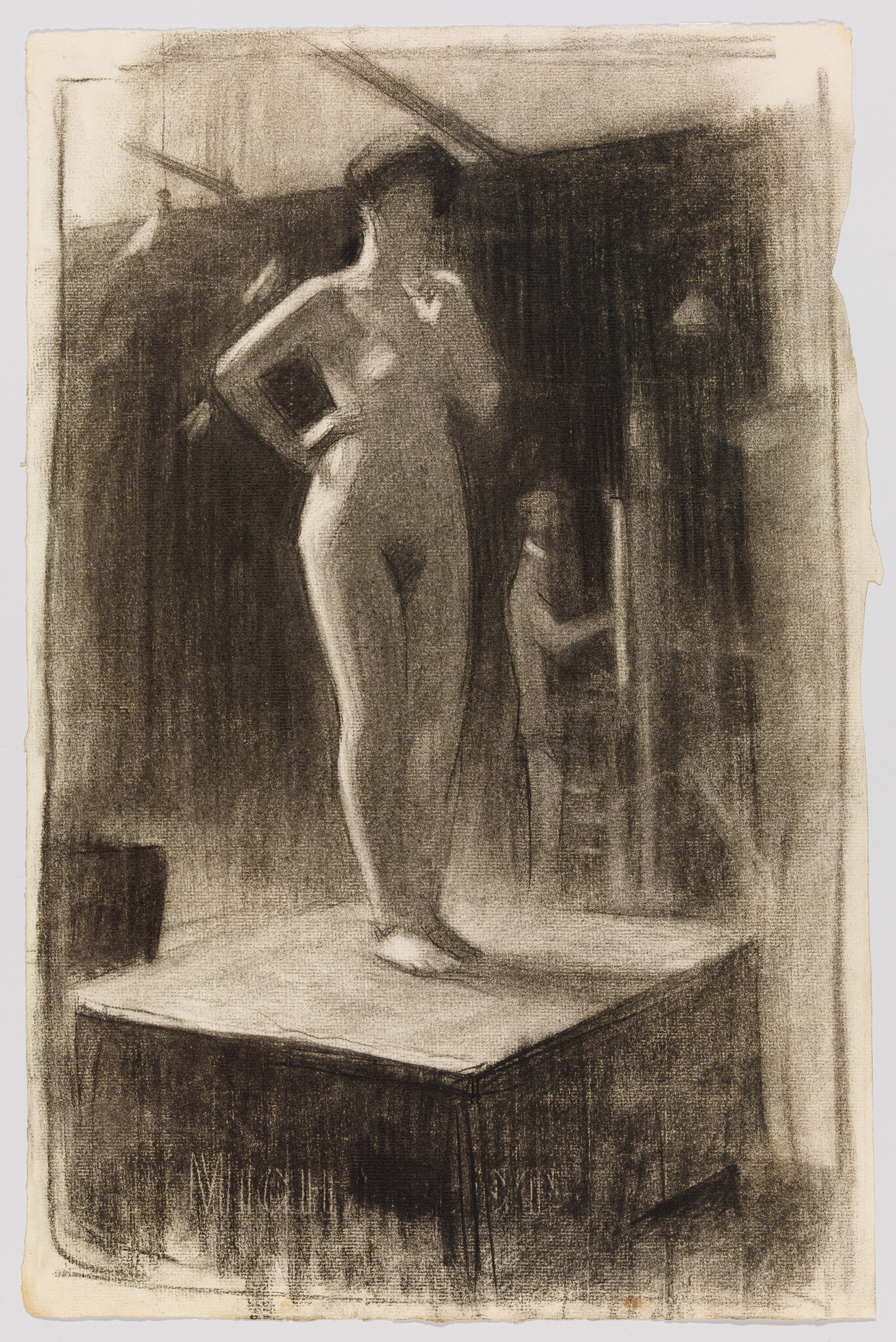 Nude female model stands on a raised platform with one hand on her hip while an assistant adjusts the backdrop.