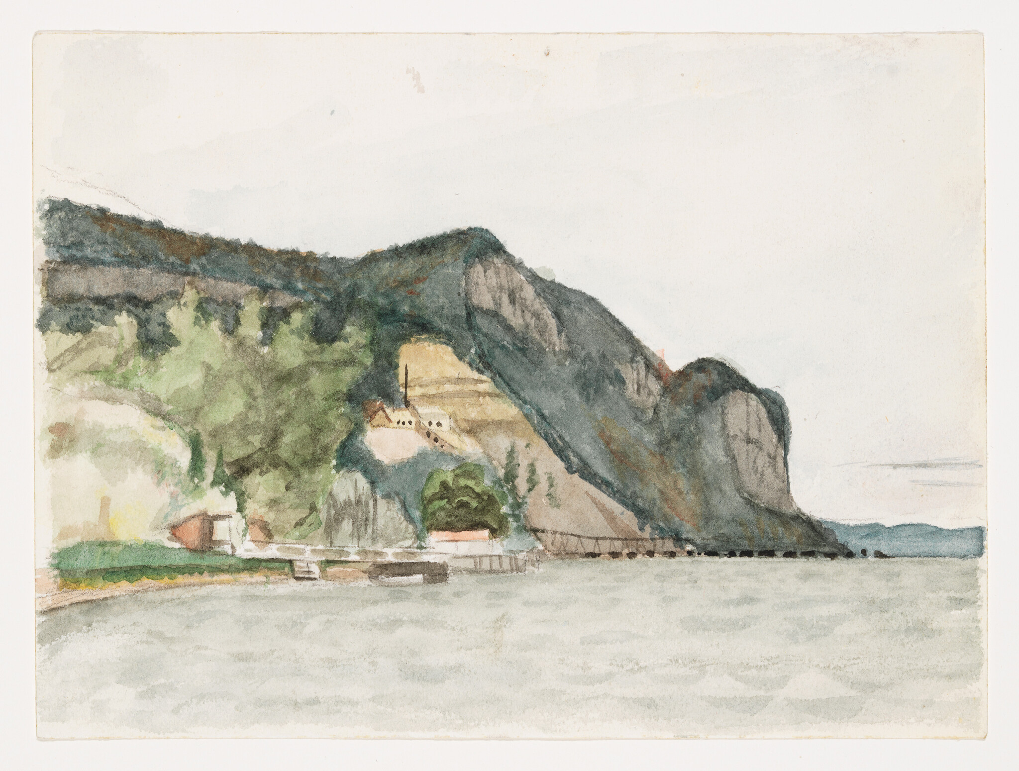 Rocky coastal cliffs rise above a small waterfront village with docks and calm gray water.