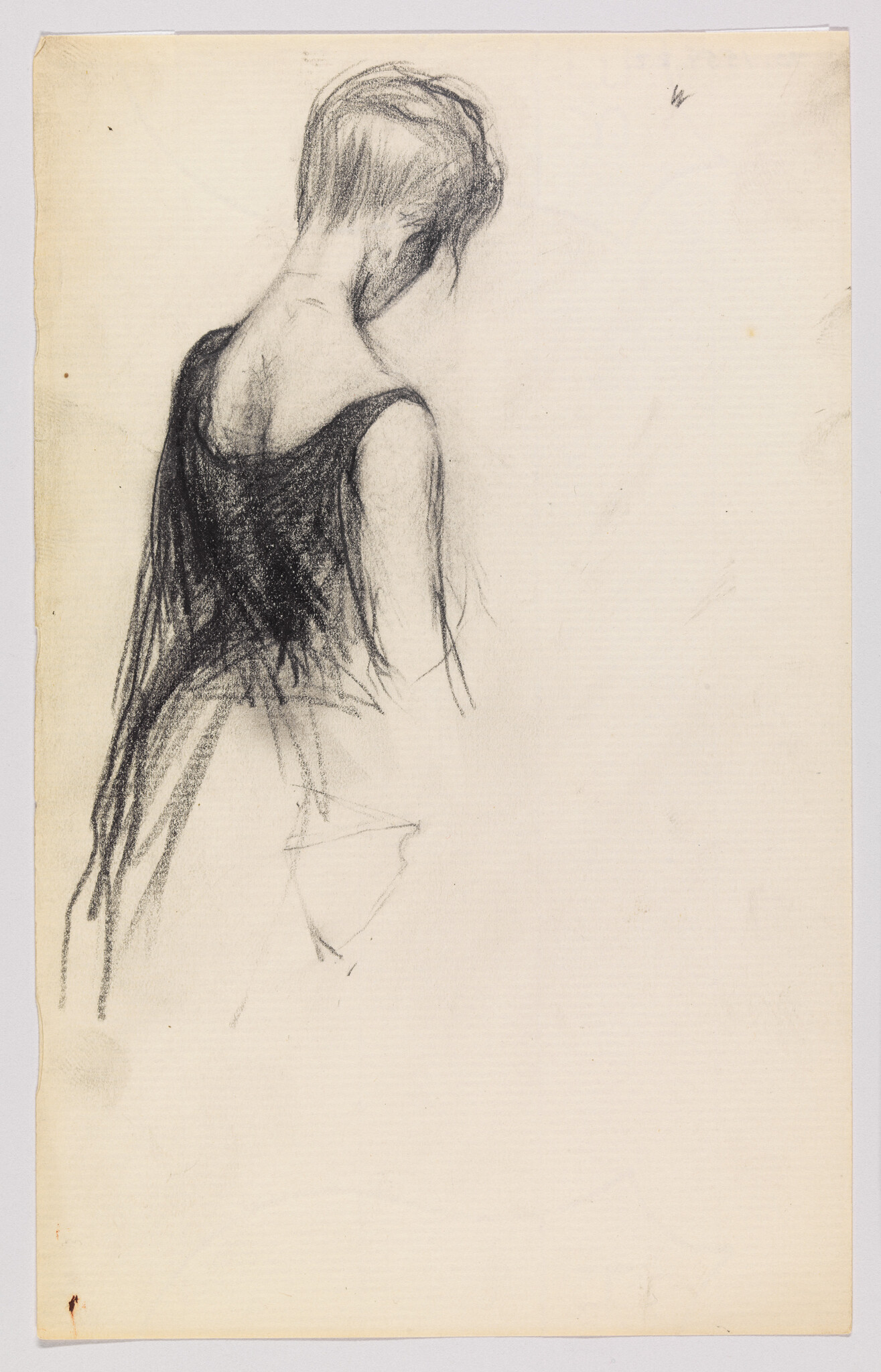 A woman with short hair wearing a dark dress turned away with her head bowed.