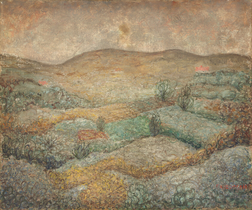 Rolling muted hills and low scrub with a few small red houses under a cloudy sky.